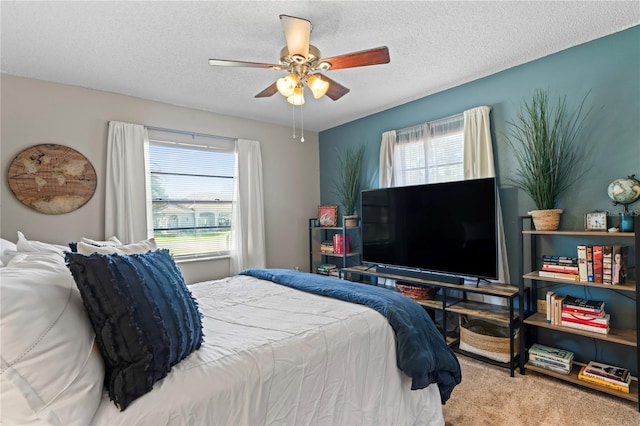 bedroom featuring ceiling fan, a textured ceiling, and carpet flooring