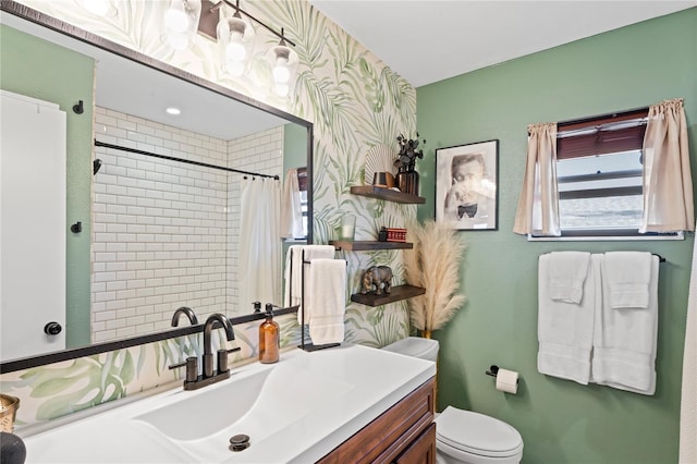 bathroom featuring toilet, curtained shower, wallpapered walls, and vanity