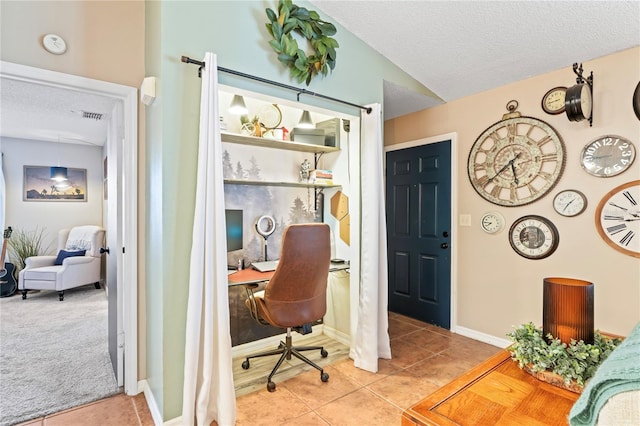 home office featuring tile patterned flooring, visible vents, and a textured ceiling