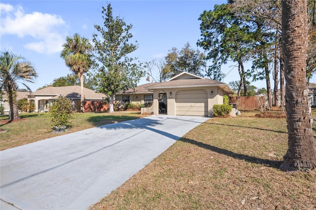 single story home featuring stucco siding, an attached garage, fence, driveway, and a front lawn