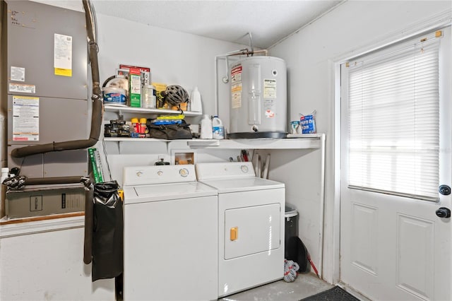 washroom featuring laundry area, water heater, a textured ceiling, and independent washer and dryer