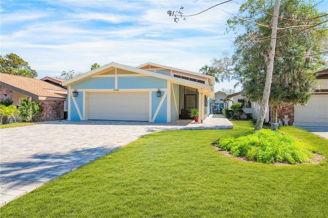 mid-century home with a garage, a front lawn, decorative driveway, and stucco siding