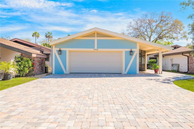 view of front of property with an attached garage, decorative driveway, and stucco siding