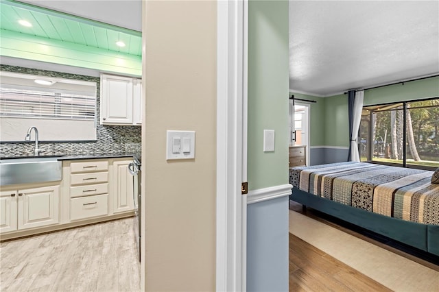 bedroom with light wood-style floors and a sink