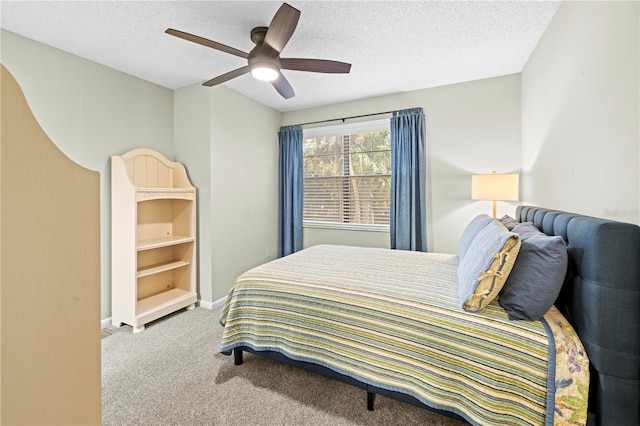 carpeted bedroom featuring ceiling fan, a textured ceiling, and baseboards