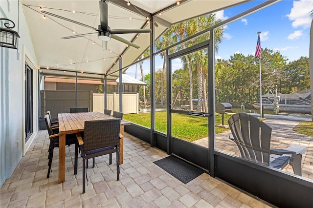 sunroom featuring ceiling fan and lofted ceiling