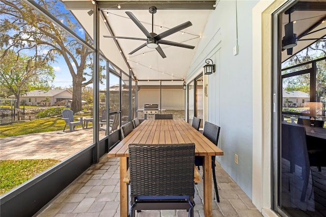 sunroom with lofted ceiling and ceiling fan