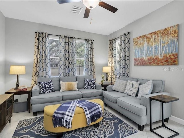 living area featuring a ceiling fan, visible vents, and baseboards