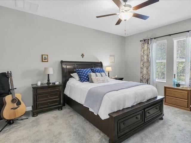 bedroom featuring light carpet and a ceiling fan