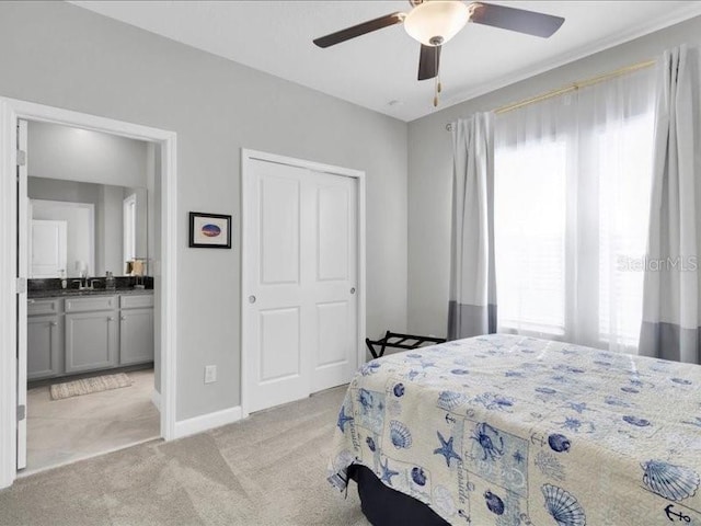 bedroom featuring light carpet, multiple windows, baseboards, and a closet