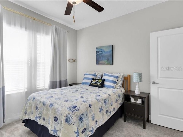 bedroom with a ceiling fan and carpet