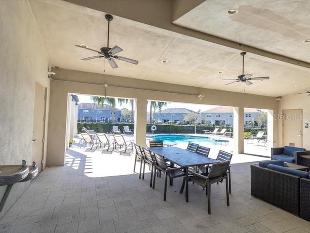 view of patio featuring ceiling fan and a community pool