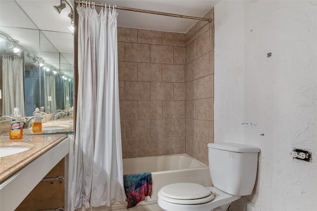 full bathroom with a textured wall, vanity, shower / bath combination with curtain, and toilet