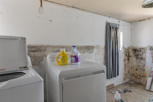 clothes washing area featuring laundry area and washing machine and clothes dryer