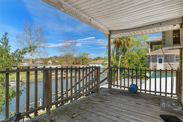 wooden terrace featuring a water view