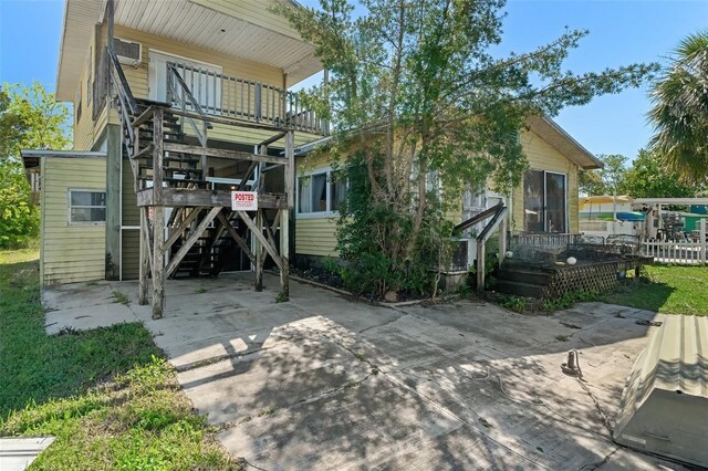 back of house featuring stairs