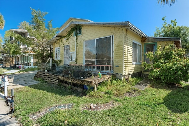 view of side of home featuring a yard