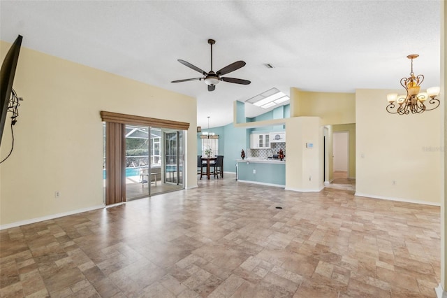 unfurnished living room with a textured ceiling, ceiling fan with notable chandelier, visible vents, baseboards, and vaulted ceiling