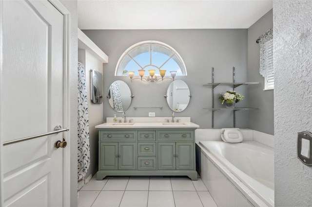 full bath featuring double vanity, tile patterned flooring, a sink, and a bath