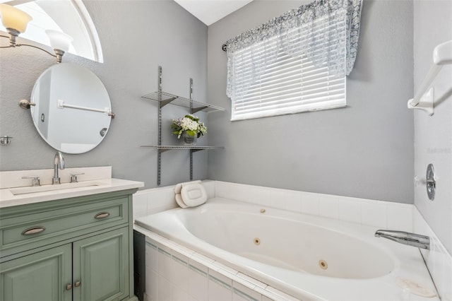 full bathroom with vanity and a tub with jets