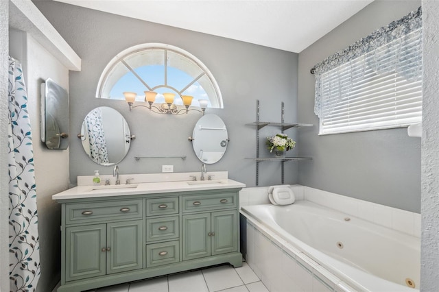 full bath featuring double vanity, a tub with jets, tile patterned flooring, and a sink