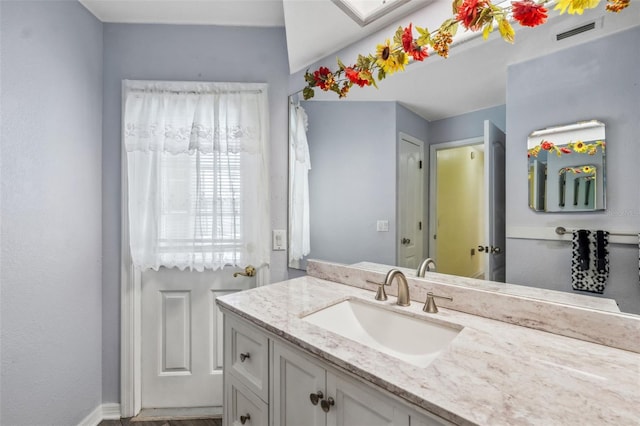 bathroom featuring vanity and visible vents