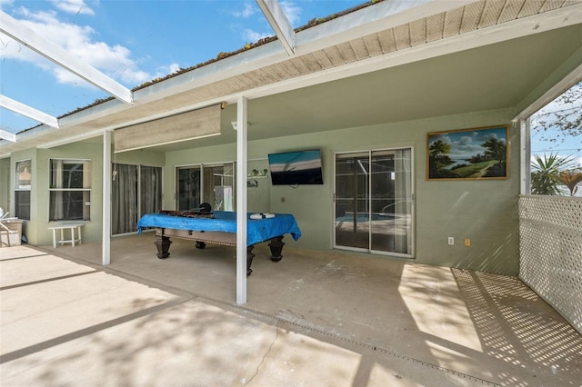 view of patio featuring a lanai