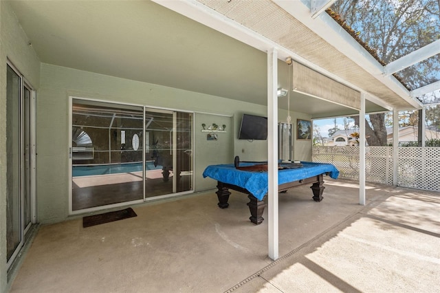 view of patio / terrace with a lanai and fence