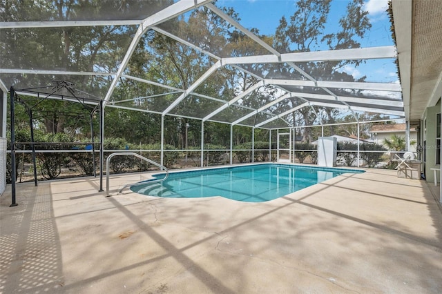 outdoor pool featuring a patio and glass enclosure