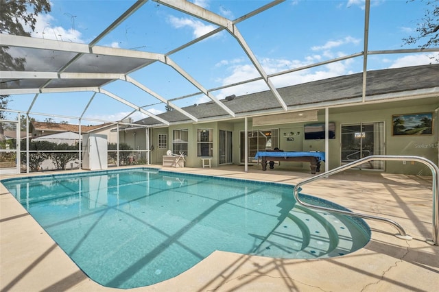 pool with glass enclosure and a patio area