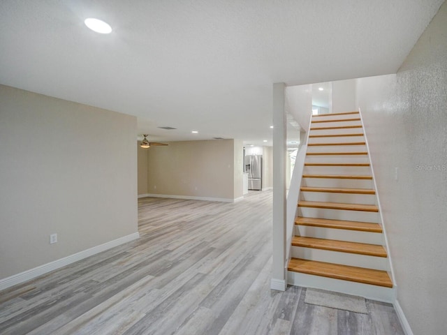 stairway with recessed lighting, wood finished floors, baseboards, and ceiling fan