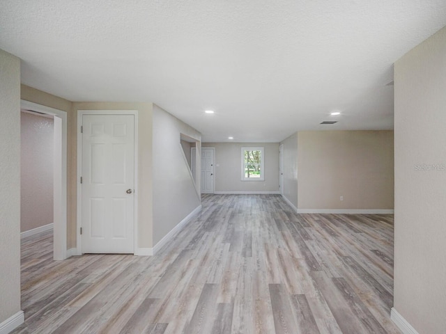 interior space with baseboards and light wood-style floors