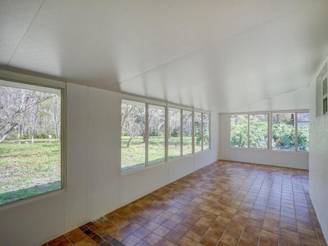 unfurnished sunroom featuring lofted ceiling