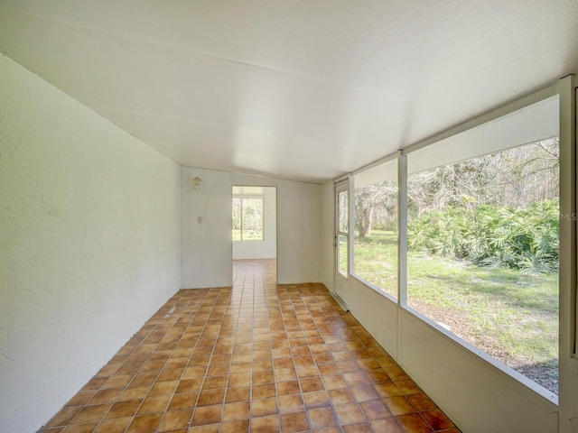 unfurnished sunroom with lofted ceiling