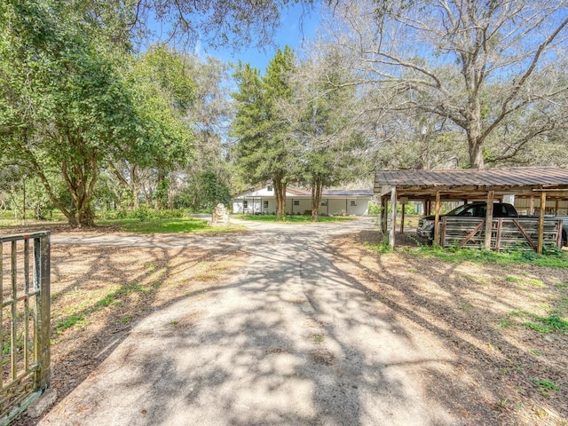 view of road featuring driveway and a gated entry