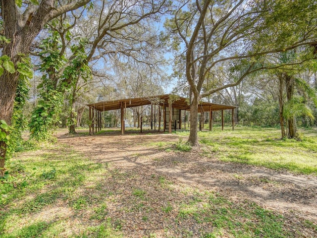 view of yard with an outbuilding and a carport