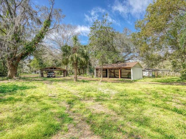 view of yard featuring an outbuilding and a detached carport