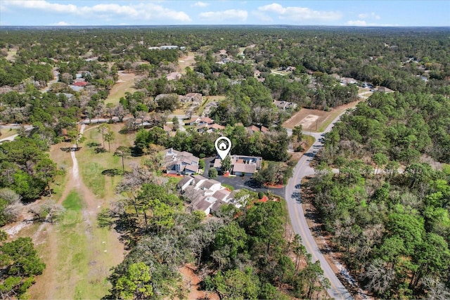 birds eye view of property featuring a view of trees