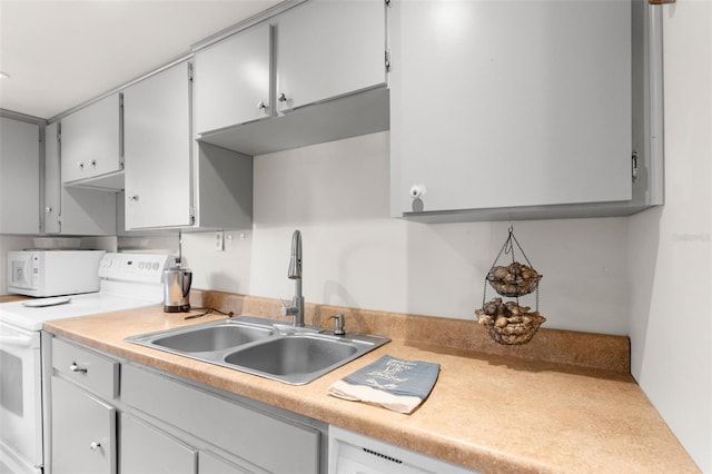 kitchen featuring a sink, white appliances, and light countertops