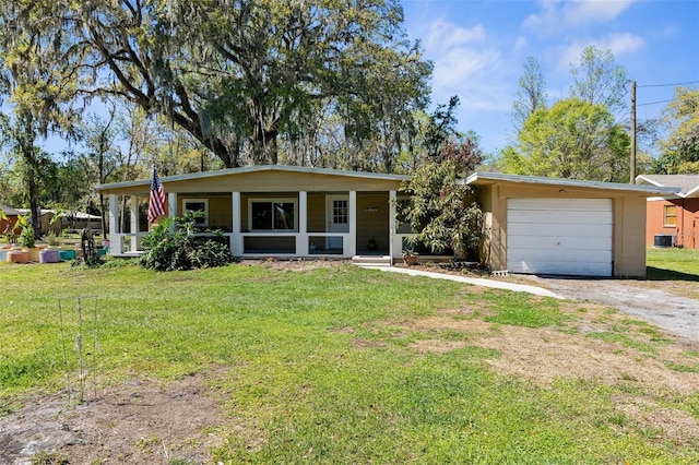 view of front of home featuring covered porch, driveway, central AC, and a front lawn