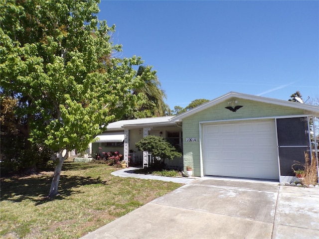 view of front facade with concrete driveway, a front lawn, and an attached garage