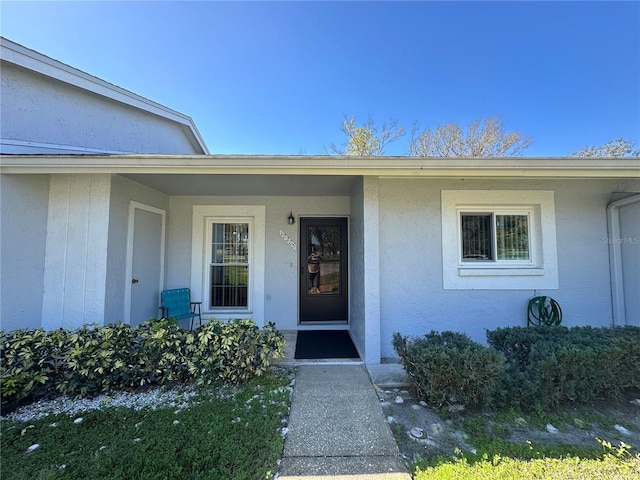 property entrance featuring stucco siding