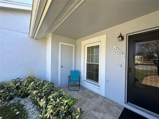 property entrance featuring stucco siding