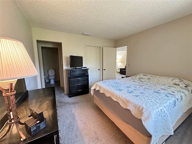 carpeted bedroom with a textured ceiling