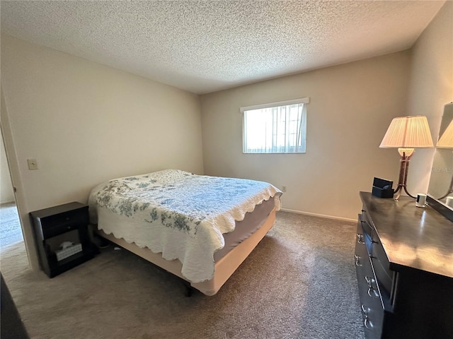 bedroom featuring a textured ceiling, dark colored carpet, and baseboards