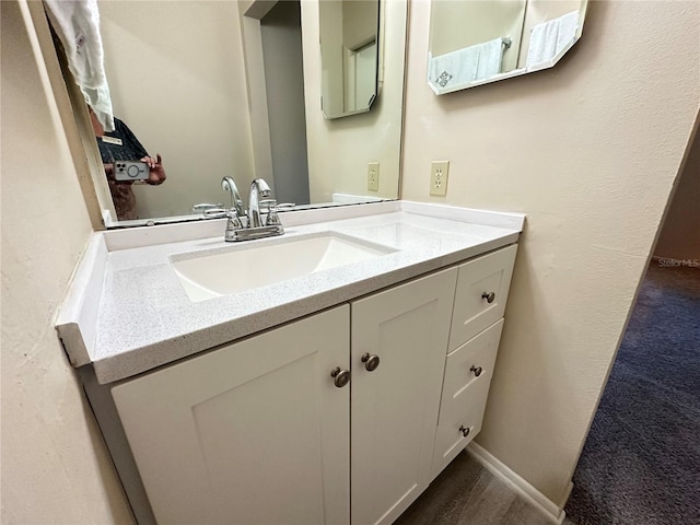 bathroom with vanity and baseboards