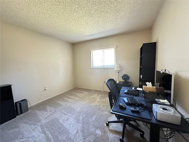 office space featuring carpet, baseboards, and a textured ceiling