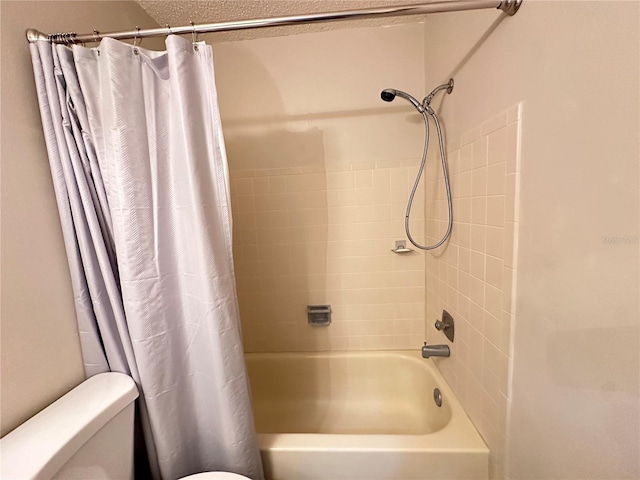 full bathroom featuring a textured ceiling, toilet, and shower / tub combo with curtain