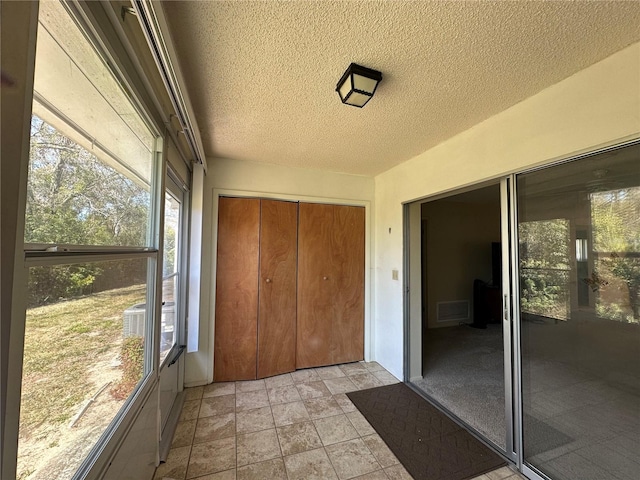 unfurnished sunroom with visible vents