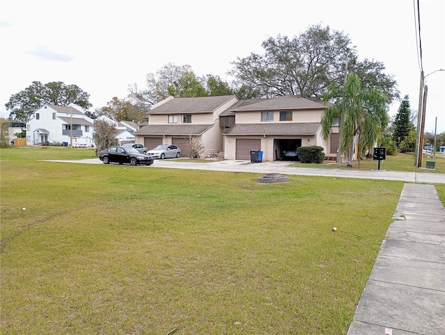 view of front of home featuring driveway, stucco siding, an attached garage, and a front yard